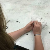 smoothing out plaster cloth mask when set